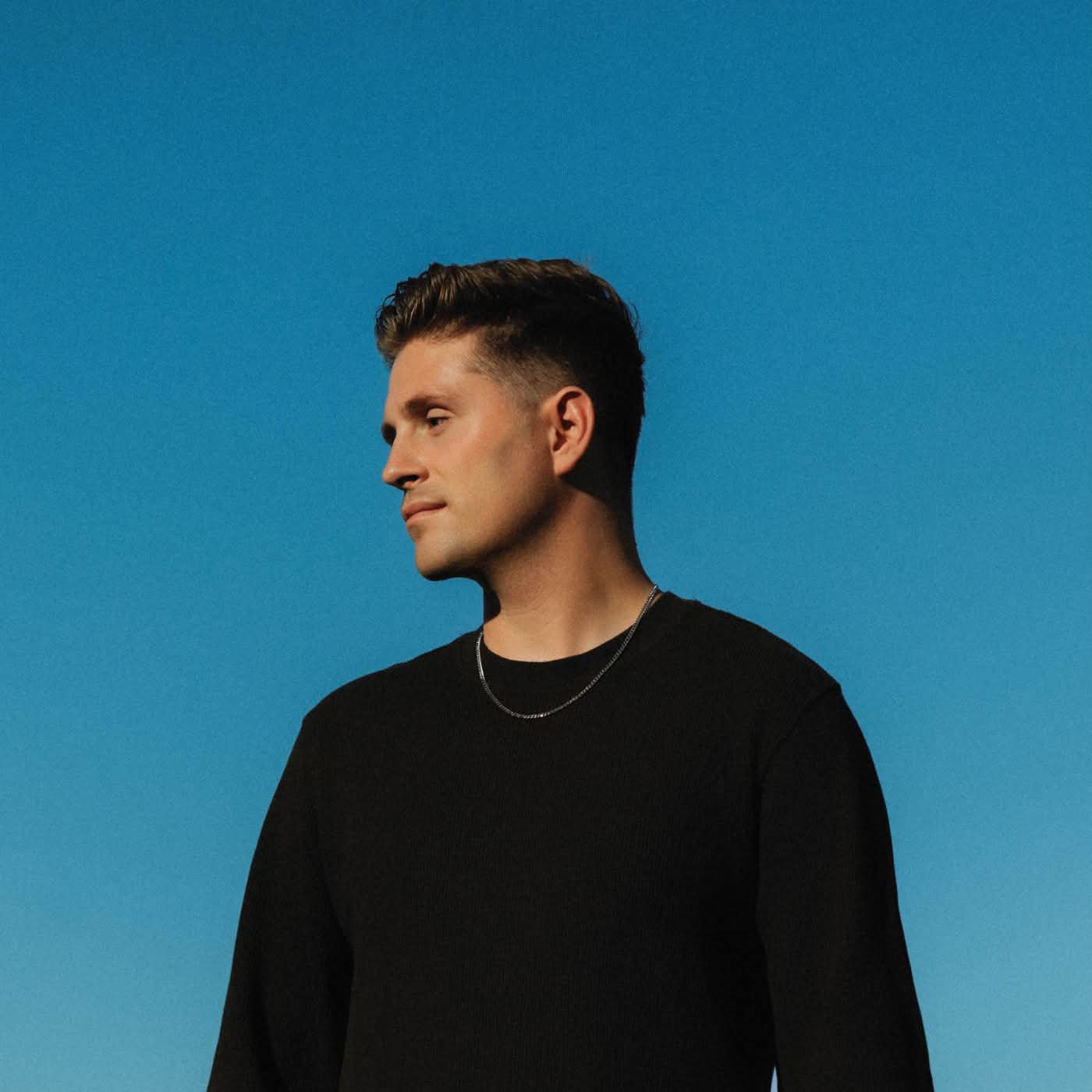 Ben Jero in profile against a blue background